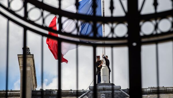 A Republican Guard lowers the French national flag at half-mast at the Elysee Palace in Paris, France, July 15, 2016, the day after the Bastille Day truck attack in Nice. - Sputnik Türkiye
