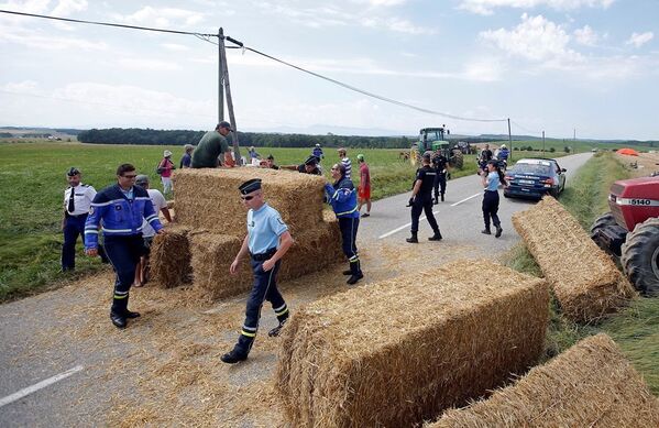 Polis memurları, saman balyalarını yoldan kaldırıyor. - Sputnik Türkiye