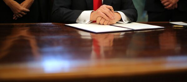 US President Donald Trump prepares to sign an executive order cutting regulations, accompanied by small business leaders at the Oval Office of the White House in Washington US, January 30, 2017. - Sputnik Türkiye