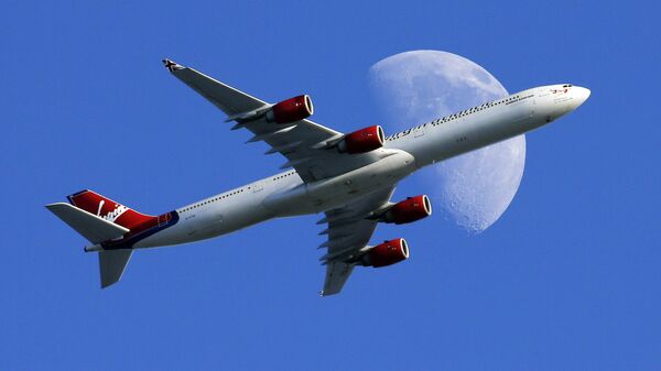 A Virgin Atlantic passenger plane crosses a waxing gibbous moon on its way to the Los Angeles International Airport, Sunday, Aug. 23, 2015, in Whittier, Calif - Sputnik Türkiye