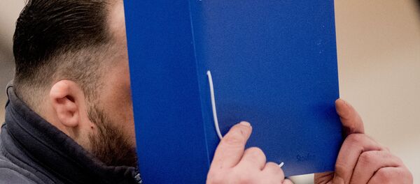 Eski hastabakıcı Niels Högel, Oldenburg'da görülen davada yüzünü kapadı. - Sputnik Türkiye