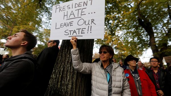 A participant in the march in memory of the victims of the Tree of Life Synagogue shooting, holds a sign opposing U.S. President Donald Trump, in Pittsburgh, Pennsylvania, U.S., October 30, 2018. - Sputnik Türkiye