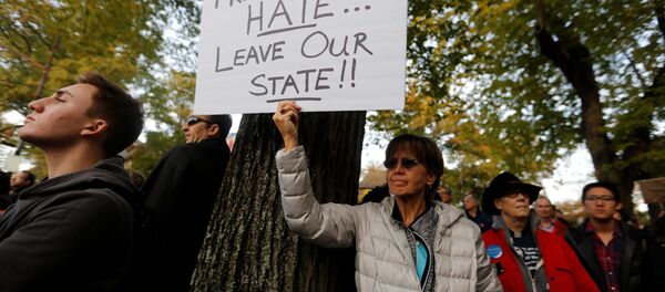 A participant in the march in memory of the victims of the Tree of Life Synagogue shooting, holds a sign opposing U.S. President Donald Trump, in Pittsburgh, Pennsylvania, U.S., October 30, 2018. - Sputnik Türkiye