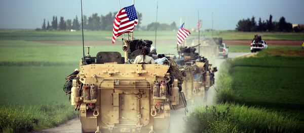 US forces, accompanied by Kurdish People's Protection Units (YPG) fighters, drive their armoured vehicles near the northern Syrian village of Darbasiyah, on the border with Turkey on April 28, 2017 - Sputnik Türkiye
