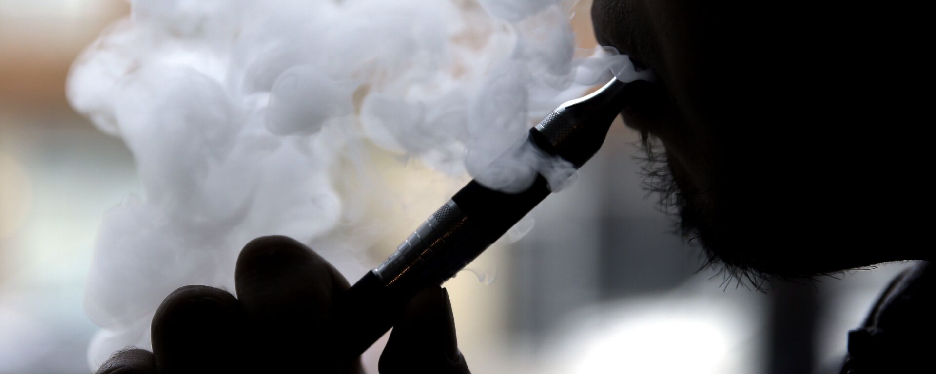 FILE - In this April 23, 2014 file photo, a man smokes an electronic cigarette in Chicago. - Sputnik Türkiye, 1920, 05.11.2025