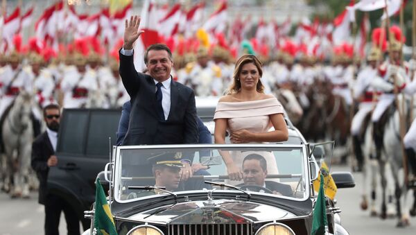 Brazil's new President Jair Bolsonaro waves as he drives past before his swear-in ceremony - Sputnik Türkiye