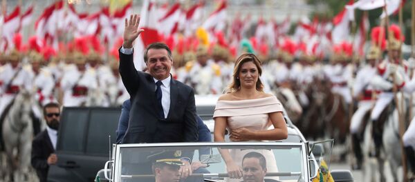 Brazil's new President Jair Bolsonaro waves as he drives past before his swear-in ceremony Brazil's new President Jair Bolsonaro waves as he drives past before his swear-in ceremony - Sputnik Türkiye