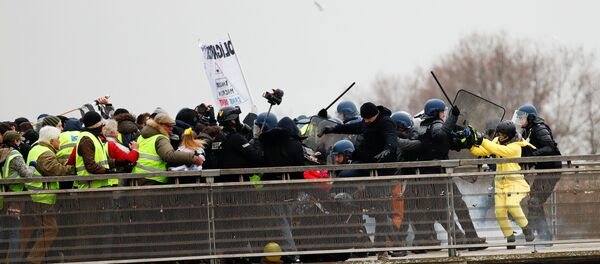Paris'in Leopold-Sedar-Senghor Köprüsü'nde Sarı Yelekler eylemcilerini sıkıştıran güvenlik gücü mensuplarını eski şampiyon boksör Christophe Dettinger fena halde dövdü. Polisle jandarmayı yumruklarıyla geri püskürtmekle kalmayıp yere düşen bir tanesini de tekmeledi. - Sputnik Türkiye