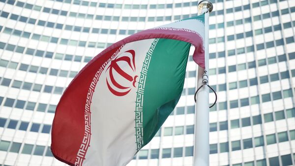 An Iranian flag waves in a wind outside the Vienna International Centre hosting the United Nations (UN) headquarters and the International Atomic Energy Agency (IAEA) as the socalled EU 5+1 talks with Iran take place in Vienna, on July 3, 2014. - Sputnik Türkiye