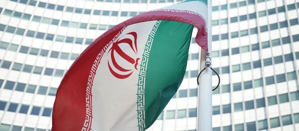 An Iranian flag waves in a wind outside the Vienna International Centre hosting the United Nations (UN) headquarters and the International Atomic Energy Agency (IAEA) as the socalled EU 5+1 talks with Iran take place in Vienna, on July 3, 2014. - Sputnik Türkiye