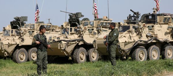 Kurdish fighters from YPG stand near U.S military vehicles in the town of Darbasiya - Sputnik Türkiye
