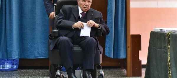 (FILES) In this file photo taken on May 04, 2017 Algerian President Abdelaziz Bouteflika is seen on a wheelchair as he votes at a polling station in Algiers. - Sputnik Türkiye