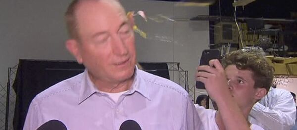In this image made from video, a teenager breaks an egg on the head of Senator Fraser Anning while he holds a press conference, Saturday, March 16, 2019, in Melbourne - Sputnik Türkiye