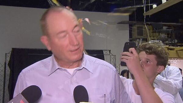 In this image made from video, a teenager breaks an egg on the head of Senator Fraser Anning while he holds a press conference, Saturday, March 16, 2019, in Melbourne - Sputnik Türkiye