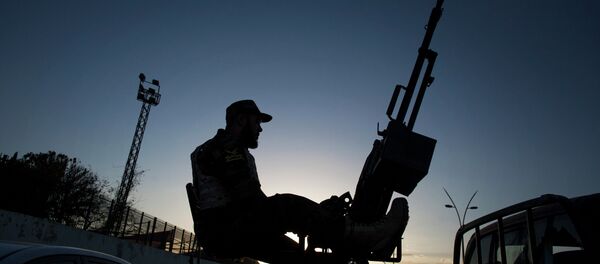 A Libyan army soldier stands guard sitting on an antiaircraft truck during the handover of the Nawaseen military compound, which was the headquarters of Libyan militias, in Souk al-Juma district, Tripoli, Libya - Sputnik Türkiye