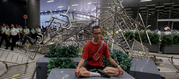 Hong Kong'da yasal konsey önünde çatışmalar yaşanırken protestoculardan biri meditasyon yapma yoluna gitti. Hong Kong'da yasal konsey önünde çatışmalar yaşanırken protestoculardan biri meditasyon yapma yoluna gitti. - Sputnik Türkiye
