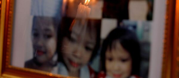 Cenaze töreninde 3 yaşındaki Myca Ulpina'nın fotoğrafları önünde mum ışığı yanarken - Sputnik Türkiye