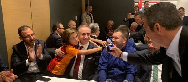 Galatasaray-Fenerbahçe derbi maçı sonrası, Galatasaray Başkanı Mustafa Cengiz ile fotoğraf çektirmek isteyen sarı-kırmızılı minik taraftarın fotoğrafını Fenerbahçe Başkanı Ali Koç çekti. - Sputnik Türkiye